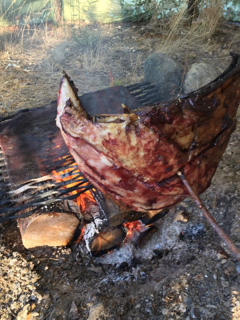 Meat being smoked over a fire